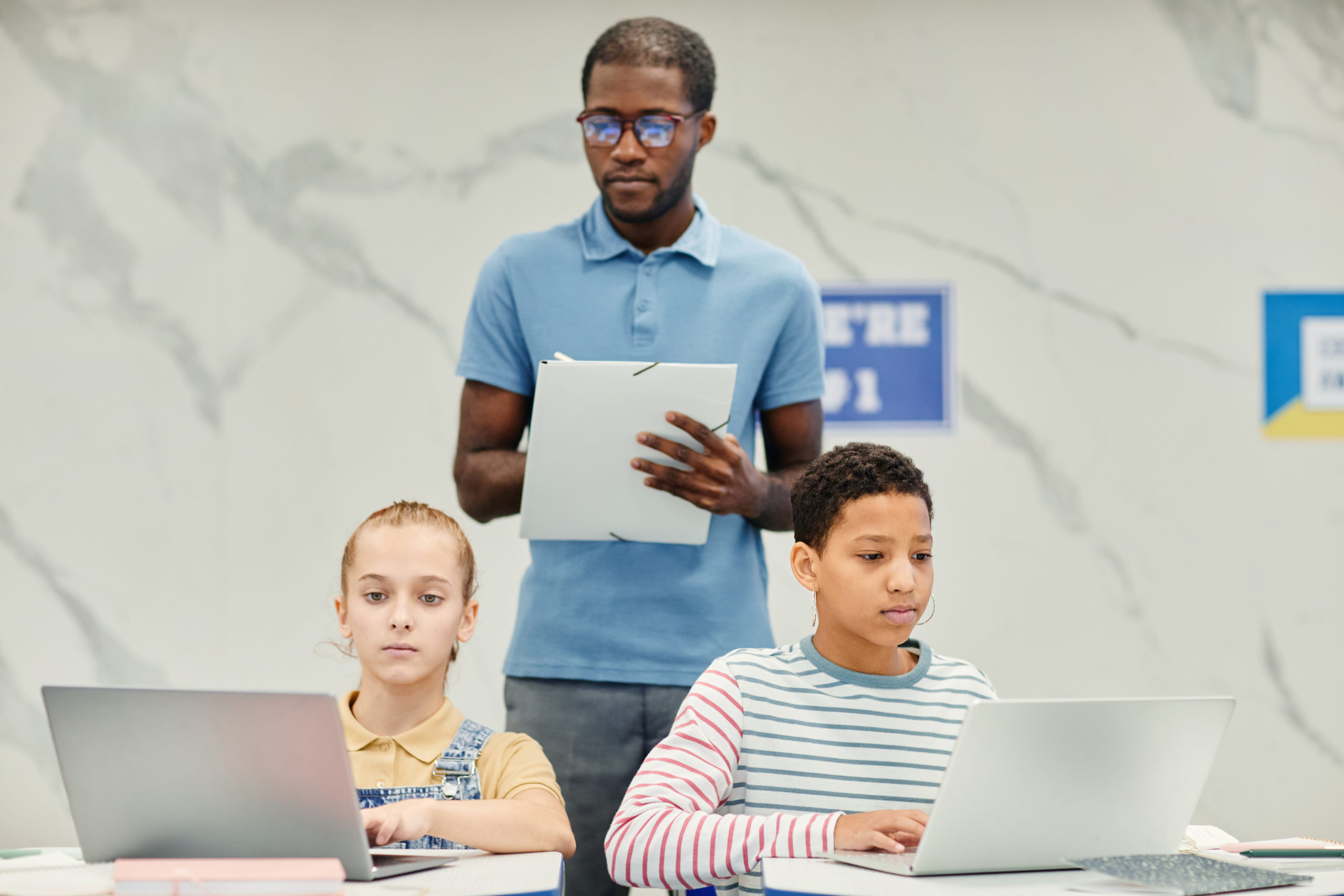 Featured image of students taking assessments in school